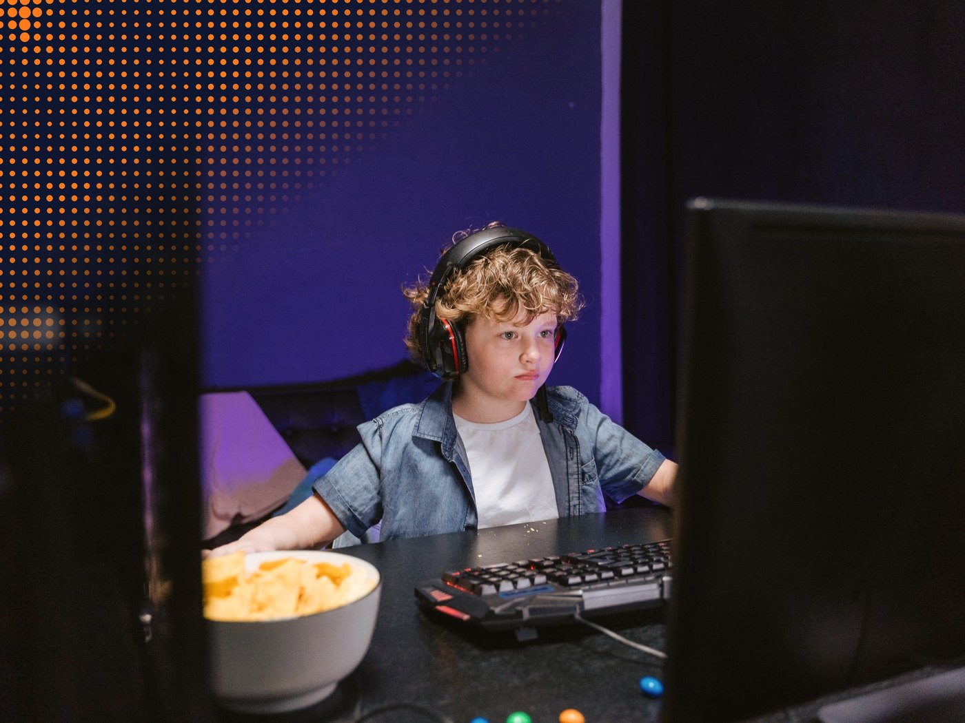 Niño con audífonos jugando en el computador